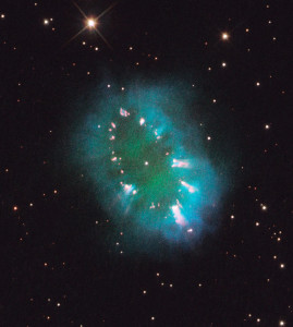 The "Necklace Nebula" is located 15,000 light-years away in the constellation Sagitta (the Arrow). In this composite image, taken on July 2, 2011, Hubble's Wide Field Camera 3 captured the glow of hydrogen (blue), oxygen (green), and nitrogen (red). The object, aptly named the Necklace Nebula, is a recently discovered planetary nebula, the glowing remains of an ordinary, Sun-like star. The nebula consists of a bright ring, measuring 12 trillion miles wide, dotted with dense, bright knots of gas that resemble diamonds in a necklace. Image: NASA, ESA, and the Hubble Heritage Team